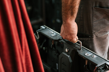 Hand of anonymous man standing and carrying LED video panel