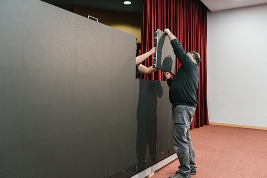 Anonymous man handing over LED display panel
