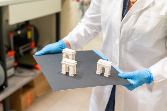 Scientist Holding Samples Printed Using 3D Printer