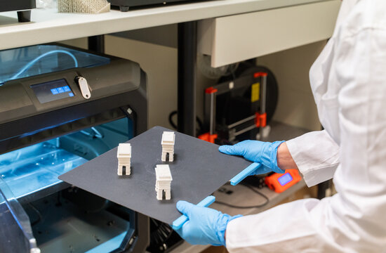 Scientist Holding Samples Printed Using 3D Printer