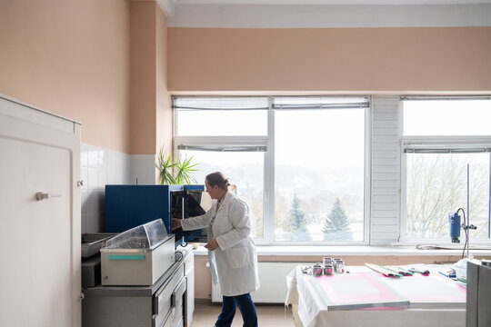 Researcher Using Scientific Equipment In Lab Room