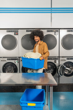 Man with Laundry Basket at Laundromat