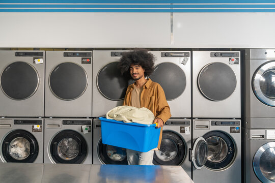 Smiling Man Holding Laundry Basket