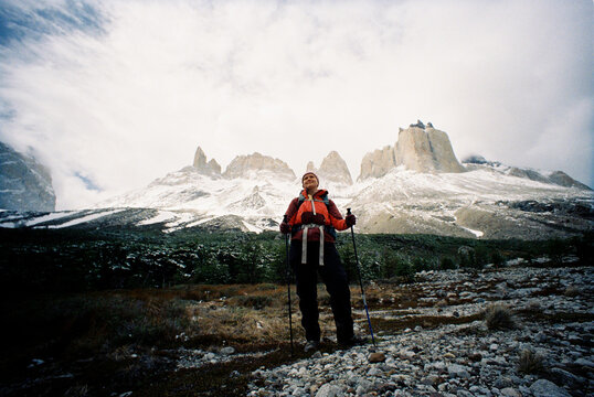 Woman standing in front of Patagonia mountains towers