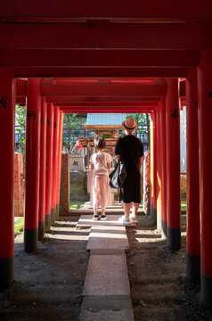 Asian mother and daughter praying in Japanese temple