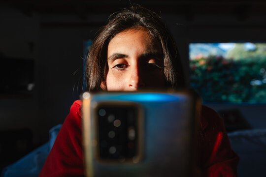 Bored young Adult Woman Scrollin on cell Phone