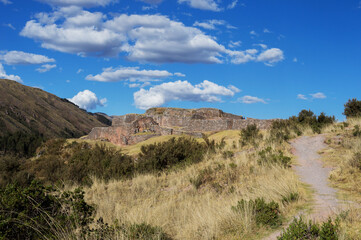 Puca Pucara archaeological site under blue sky with clouds in the Sacred Valley of the Incas