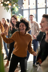 Fototapeta premium Happy young woman dancing and celebrating new year resolutions with friends