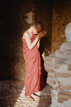 Novice monk praying in the ancient temple