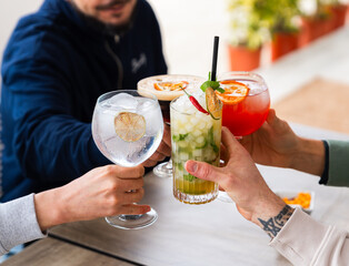 Friends enjoying cocktails together outdoors
