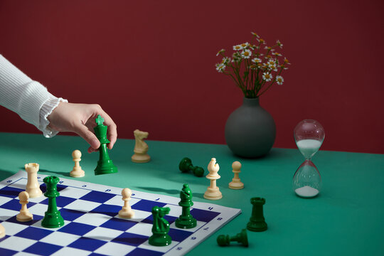 woman playing chess and holding the queen