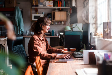 Freelance artist using pc on office table at studio