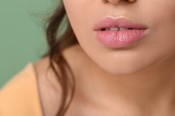 Fototapeta premium Woman with beautiful lips on green background, closeup