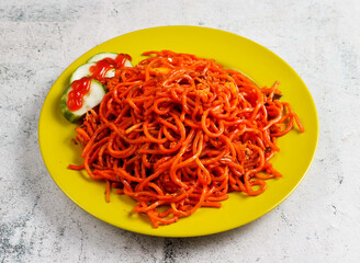 mee goreng with cucumber salad served in dish isolated on grey background side view of singapore food