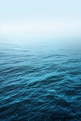 Fototapeta premium Tranquil Blue Ocean Waters on a Foggy Morning