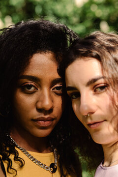 A close-up portrait looking at camera of two young women