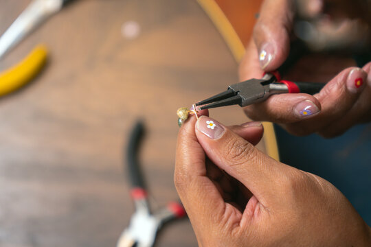 Woman making costume jewelry accessories