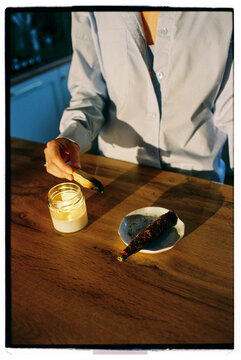 Closeup of anonymous woman burning a candle and incenses at sunset