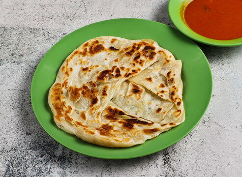 plain pratam porata or paratha with chilli sauce served in dish isolated on grey background side view of singapore food