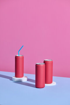 Normal soda cans in pink bright blue background