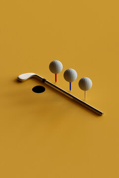 Golf Balls on Tees with Shadow and Putter on Yellow Background
