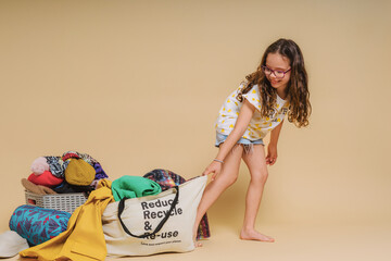 kid with recycling clothes bag 
