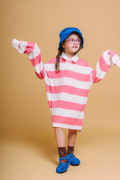 kid in oversize T shirt  with Blue Hat and Shoes