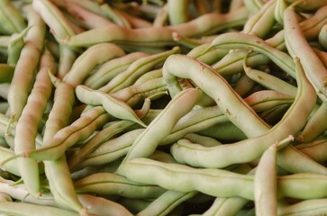 A pile of raw green beans seen up close. Selective focus. 