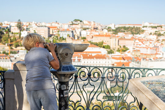 blonde boy on the one of the Lisbon viewpoint admiring of the pano