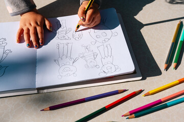 Child Drawing monsters with pencil