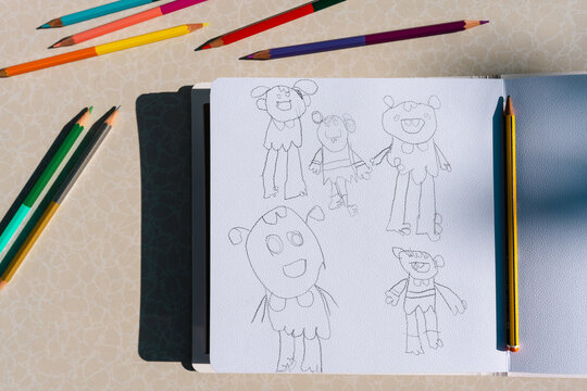 Child's Sketchbook with Colorful Pencils on Table