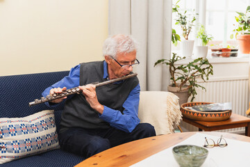 Senior man playing flute
