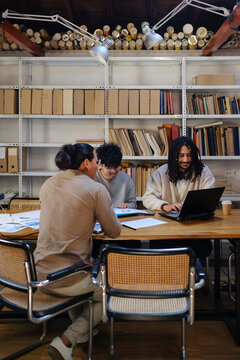 Startup Coworkers developing business plan in their messy office 