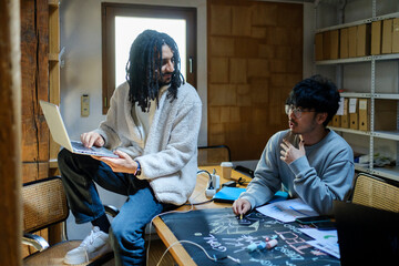 Group of coworkers brainstorming for logo in their tech startup office