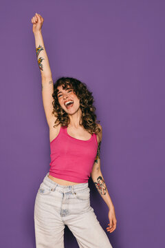 Exuberant young woman celebrating with a raised fist