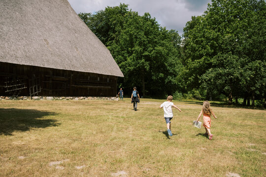 family together by thatched roof building in lower saxony germany