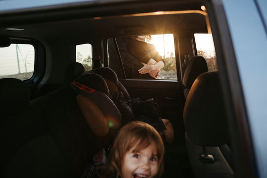 Sunset Drive With Smiling Child and Passenger