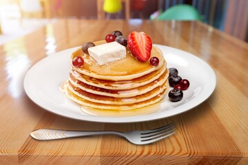 Crepes, pancakes with sauce and fresh berries