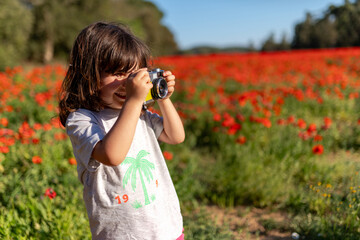 Child Taking Photos in Poppy Field