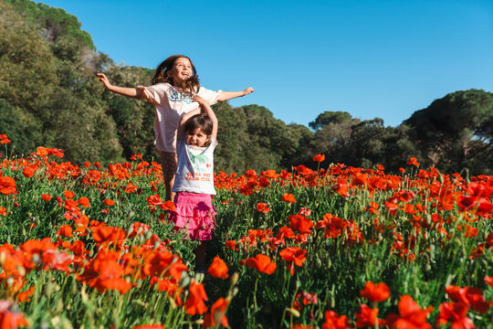 Children Playing Joyfully in a Poppy Field