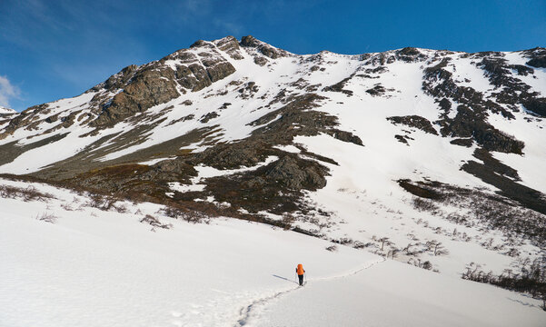 Hiker walking through a snowy patch