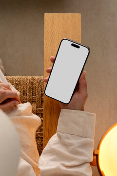 Elegant Woman Holding a Smartphone with white screen. Mockup phone
