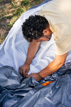 A man sets up a tent