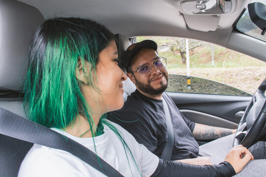 Young couple in car sharing affectionate glance
