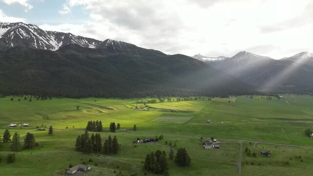 Aerial view of green fields and dense mountain woods near Wallowa Mountains in Eastern Oregon, USA