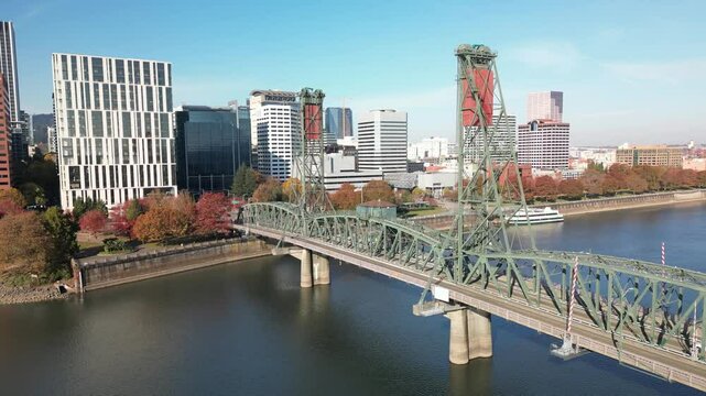 Drone footage of Morrison Bridge spans the Willamette River on a sunny day in Portland, Oregon, USA
