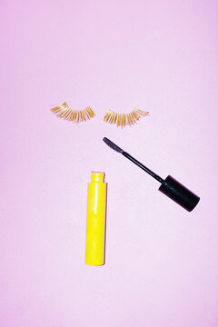Beauty products: golden shiny lashes and makeup mascara and hard flash