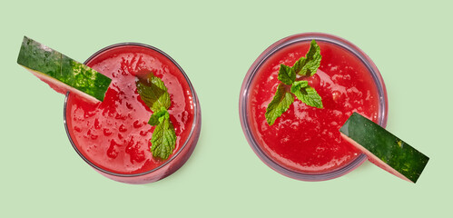 Strawberry smoothie in cup on green pastel background