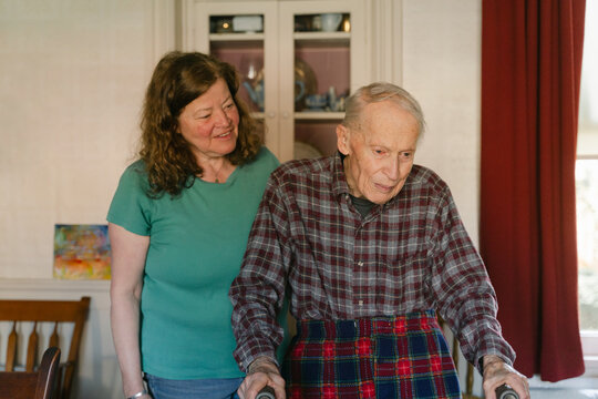 senior citizen with his daughter and caretaker  in his home 