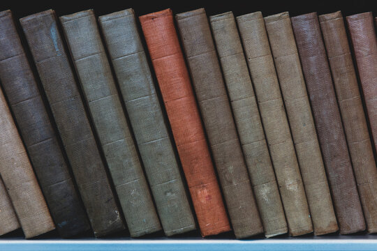 Row of old books on shelf